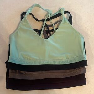 4 Under Armor sports bras. Size large. Dark grey, purple, black, light green